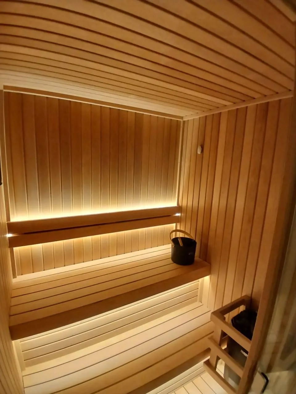 Hemlock sauna with LED strips concealed beneath both bench tiers