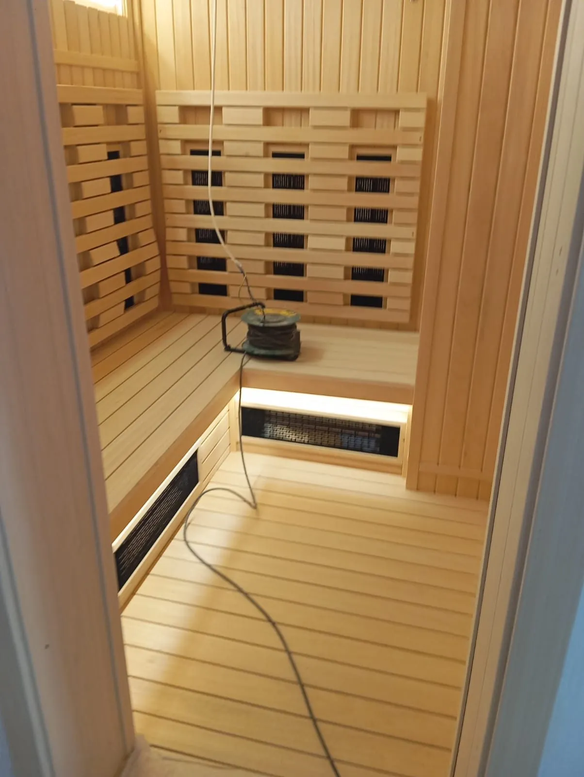 Carbon heater panels fitted behind the backrest of an infrared sauna