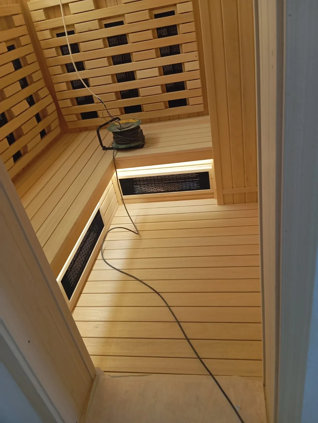 Hemlock lined infrared sauna interior with floor level heater