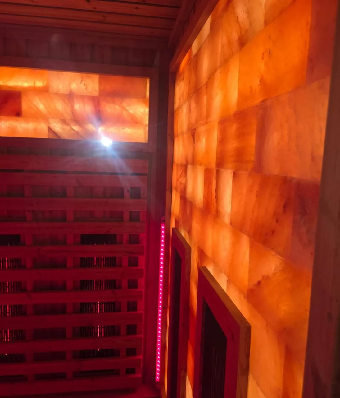 Infrared carbon panels facing a backlit Himalayan salt brick wall