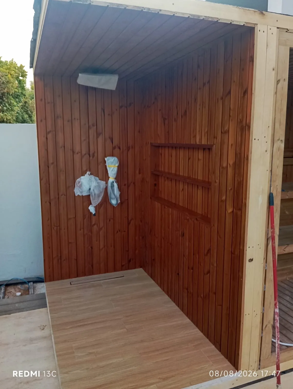 Outdoor sauna cabin clad in timber and nearing completion