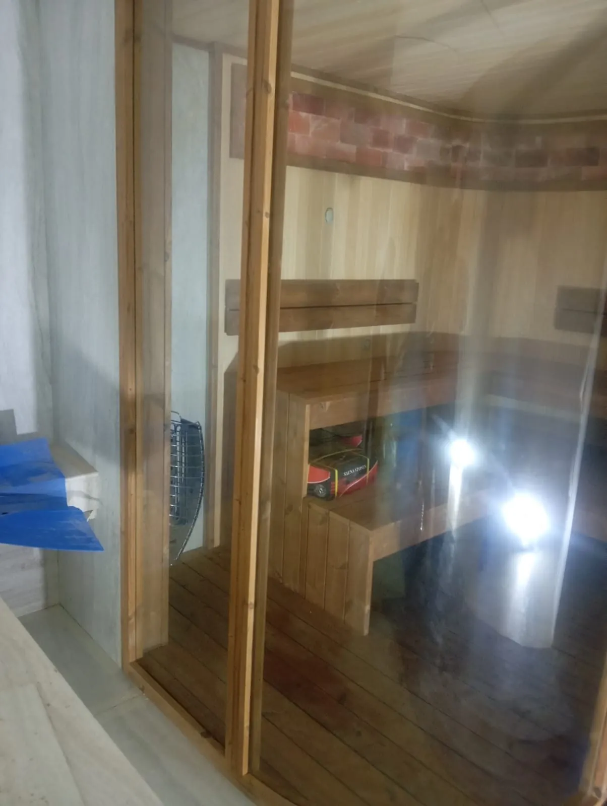 Close detail of a sauna glass door and frame junction