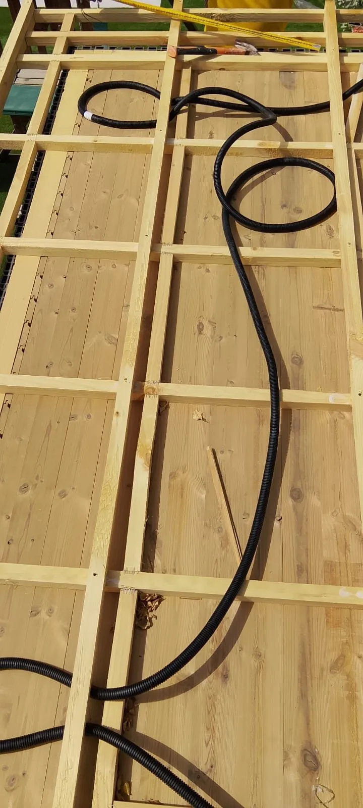 Electrical conduit run through the timber frame of a sauna wall